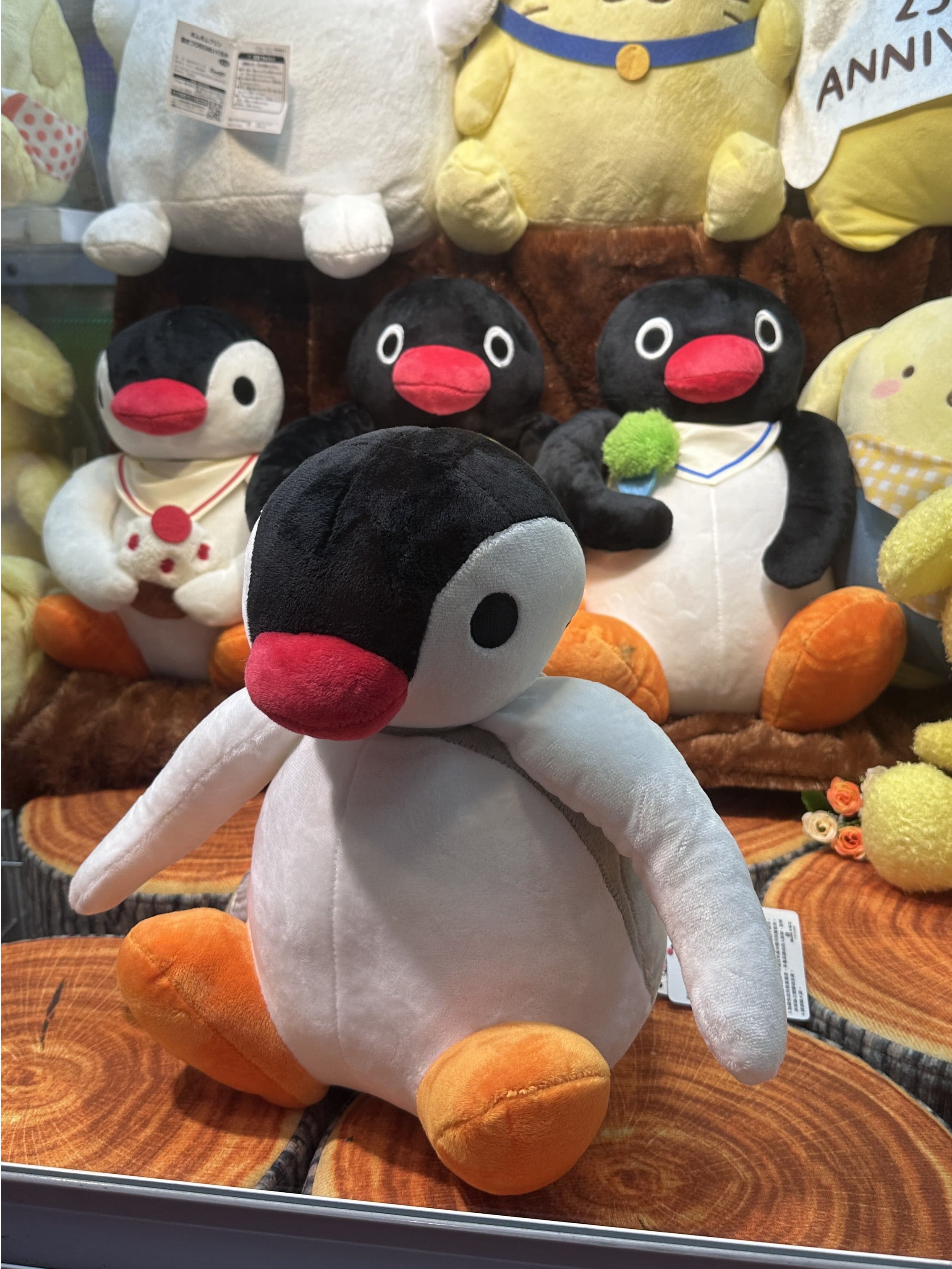 Penguin plushies in a claw machine in Downtown East