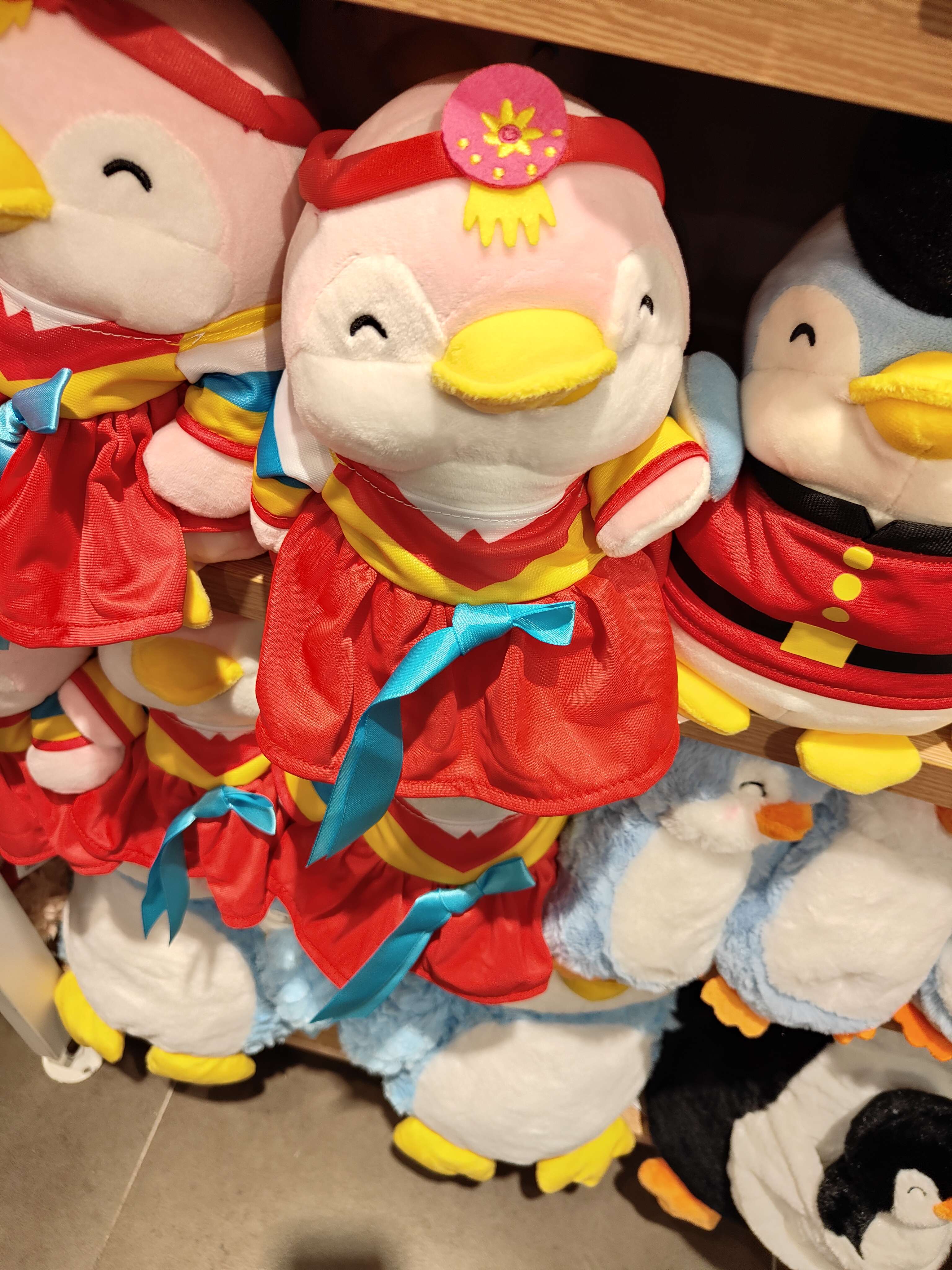 Penguin plushie in different cultural costumes